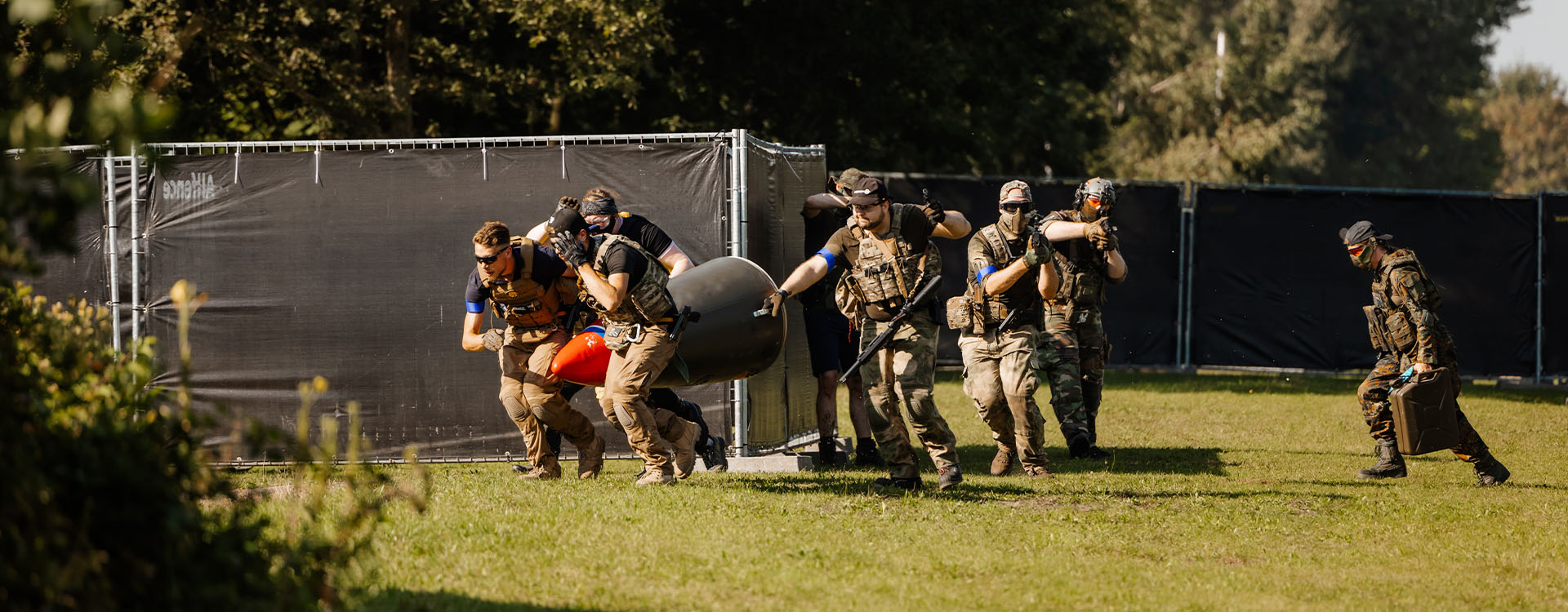 Airsofters op een skirm locatie buiten vervoeren verschillende objecten.